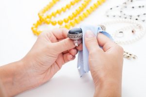 Polishing silver old-fashioned jewellery with a cloth