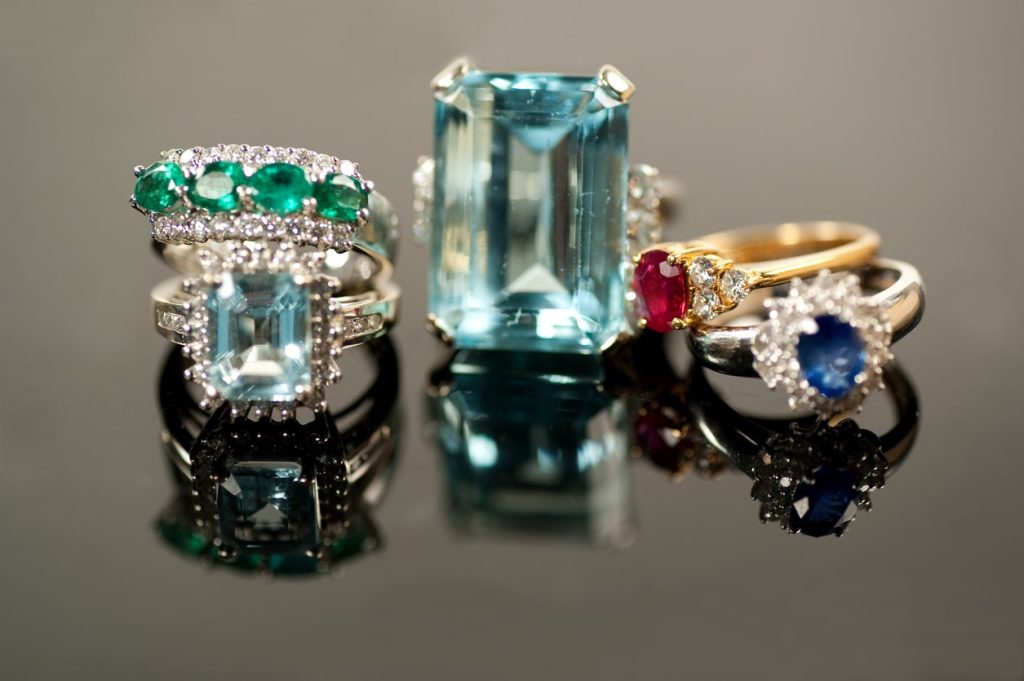 cocktail rings with different gemstones sitting on a table