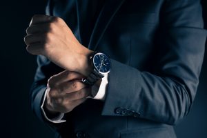 Businessman checking time from watch