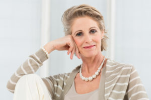 Portrait Of Happy Mature Woman Wearing Necklace