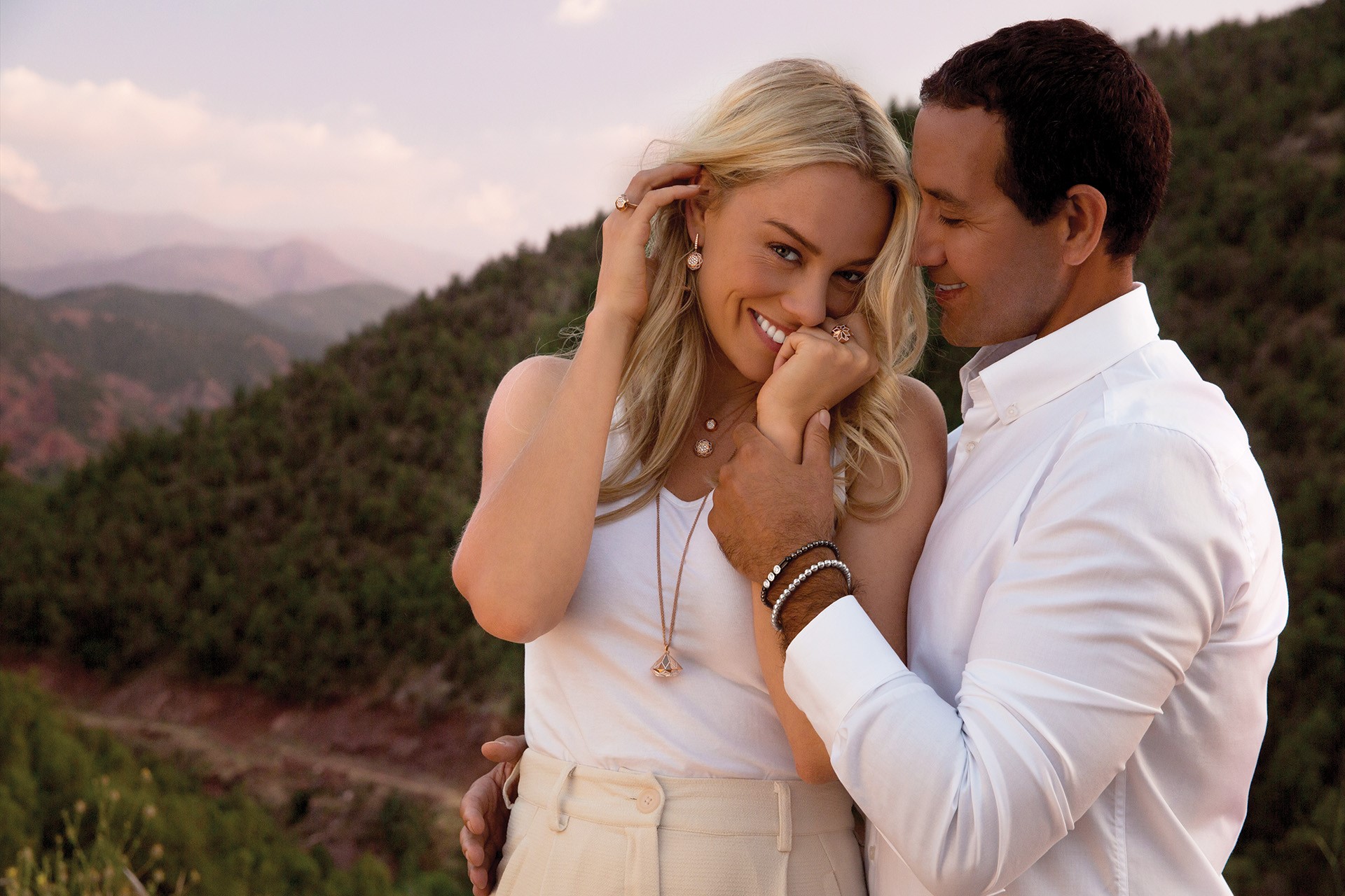 Tender black couple hugging with closed eyes outdoors