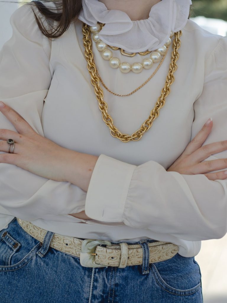 woman wearing fall weather outfit with layered gold chains