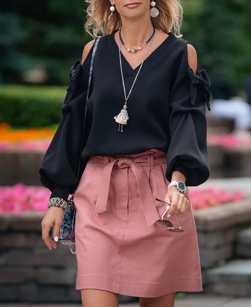 woman wearing long pendant necklace